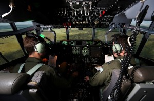 RAAF Flight Lieutenant (FLTLT) Flynn Kenney (left) and FLTLT Clinton Baldock of No 285 Squadron fly a mission in the C-130J Full-Flight Mission Simulator during Coalition Virtual Flag 15. © Commonwealth of Australia, Department of Defence